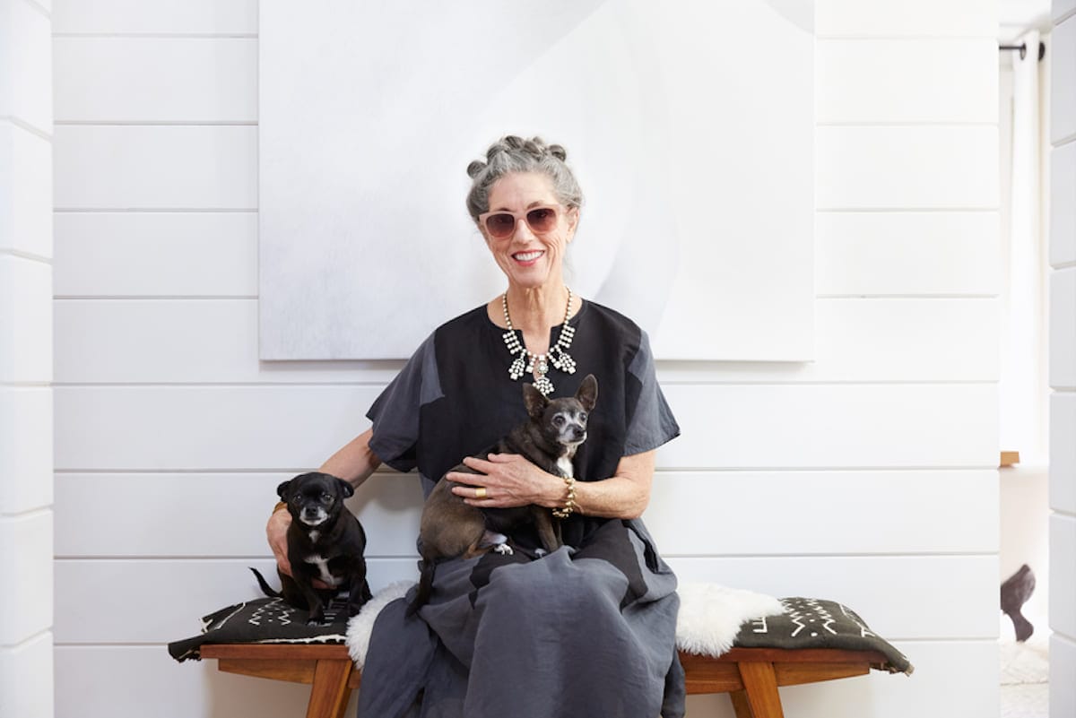 Stylish senior woman sits with her dog