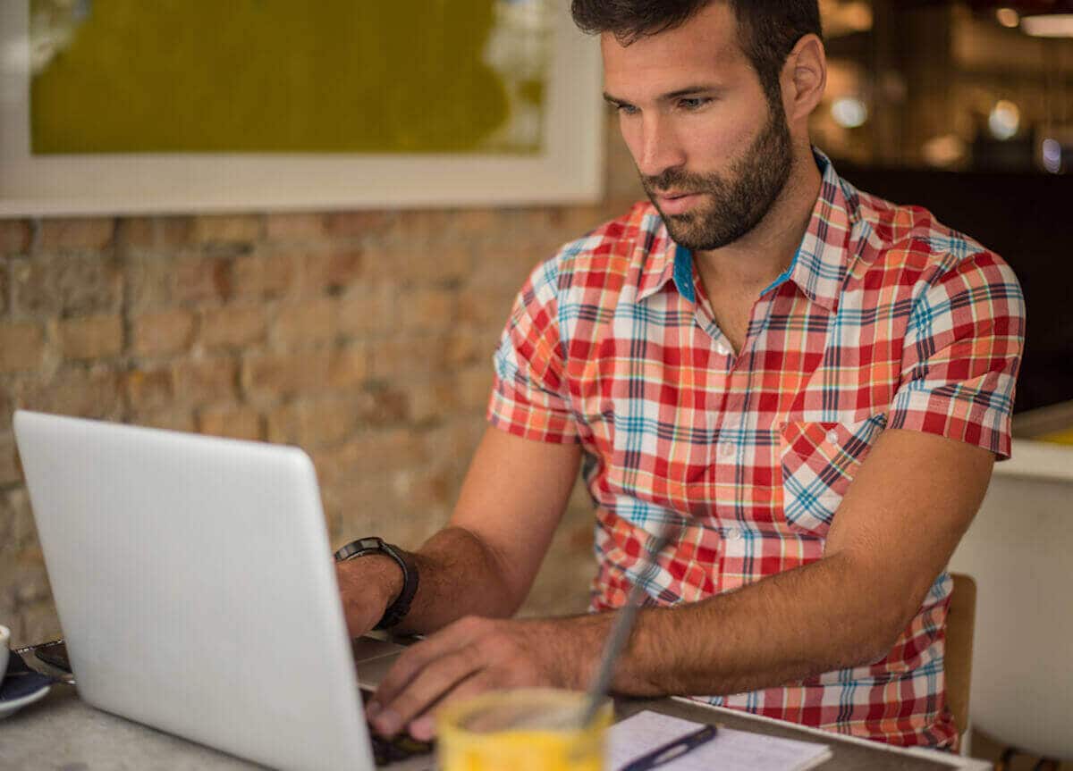 Male freelancer works on a laptop computer