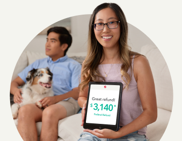 TurboTax customers Diana and Brian sitting on the couch. Diana is holding a tablet that shows her federal refund amount of $3140.