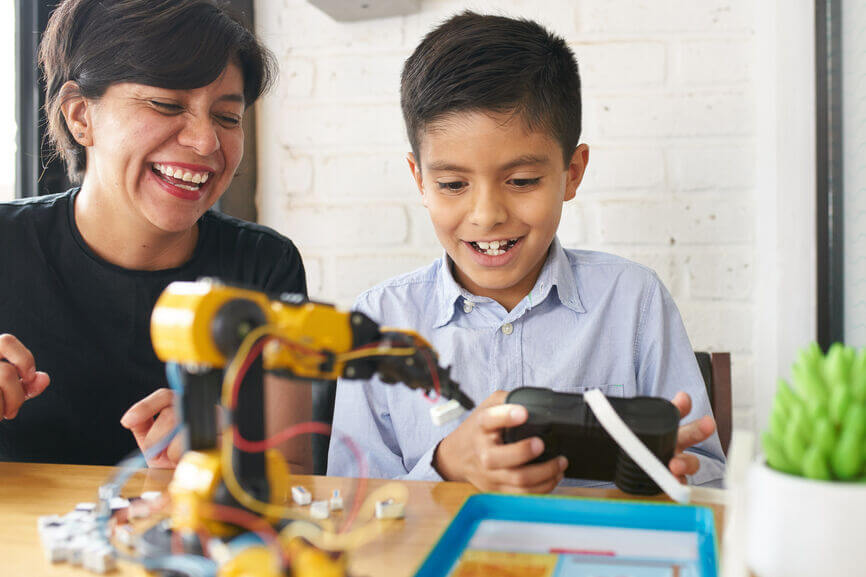 Woman and her son playing with robotics