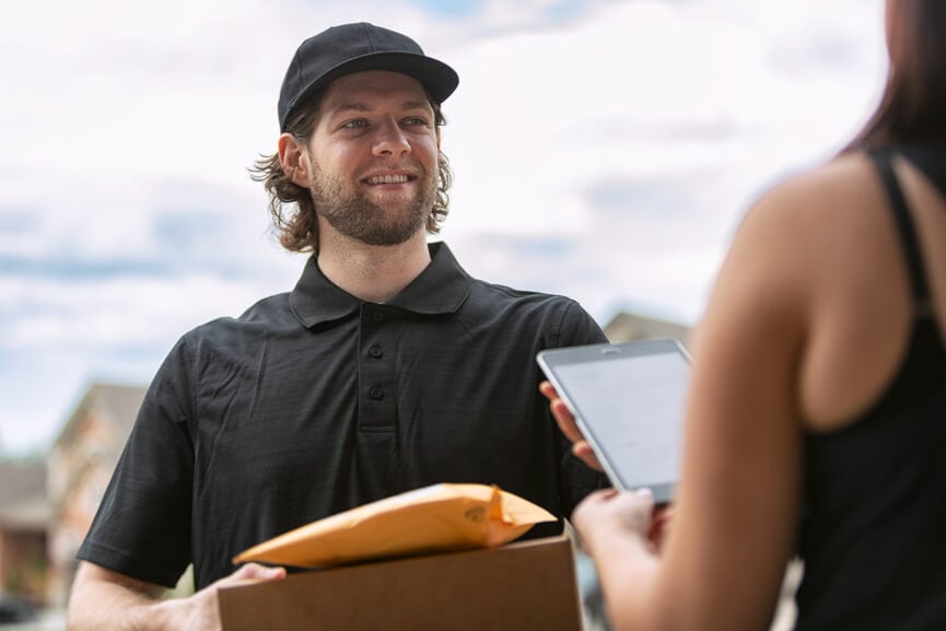 Worker delivering packages to person
