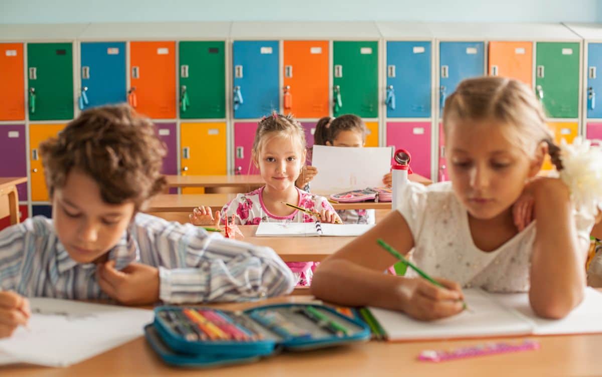 children at desks in classroom