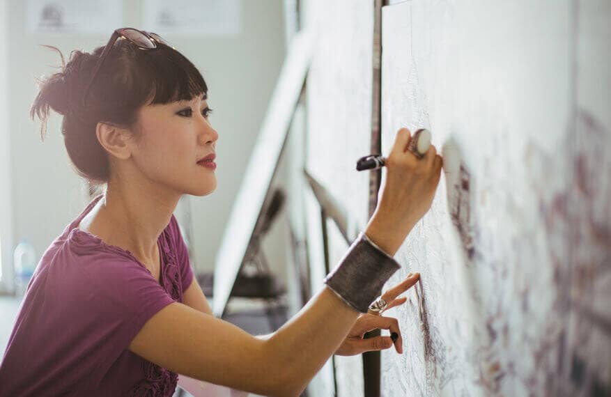 Woman artist drawing on a canvas.