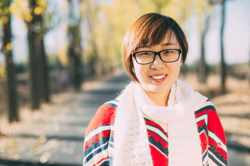 Chinese woman smiling in a park