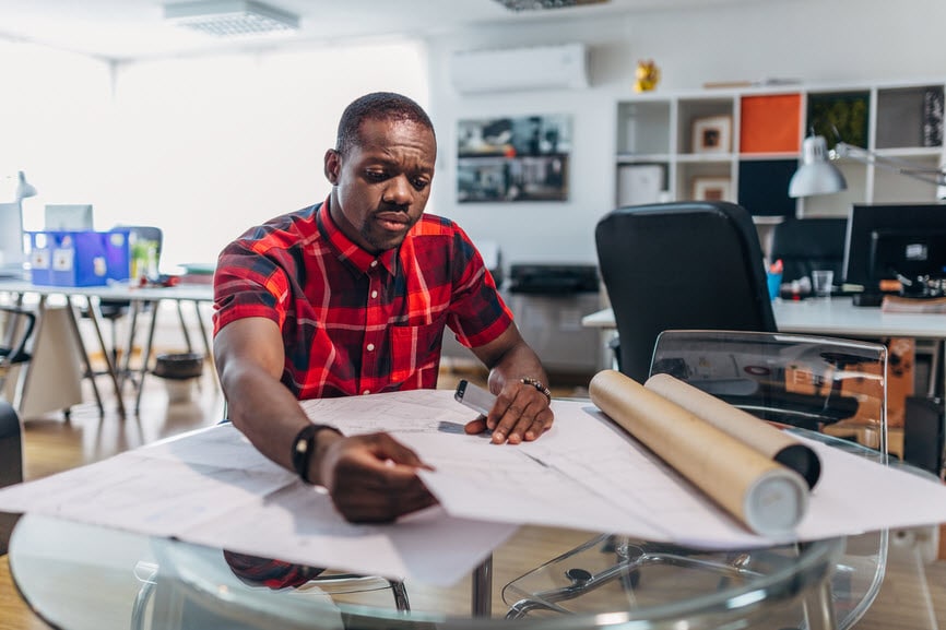 Man working with plans on a table