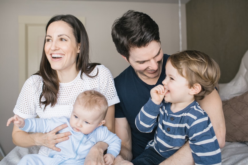 Happy parents play with their kids after amending their taxes.