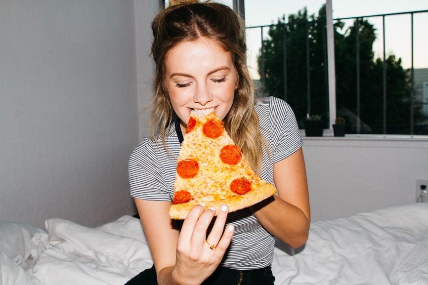 Girl eating pizza.