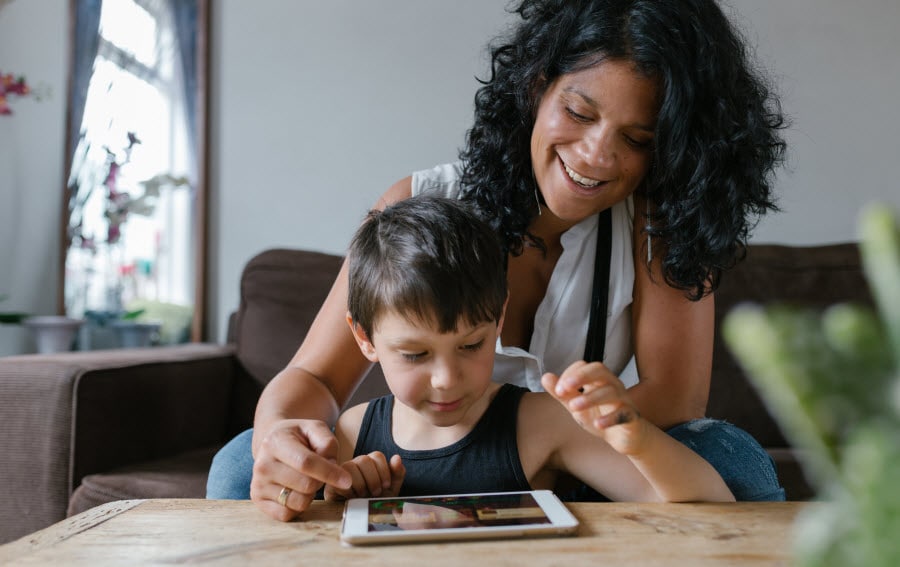 Mom playing with son on iPad