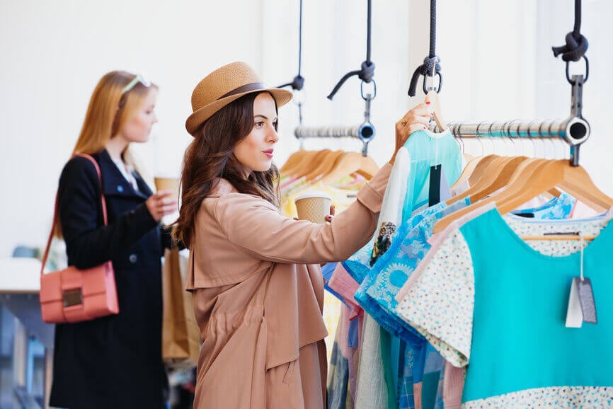 two friends shopping in a boutique clothing store
