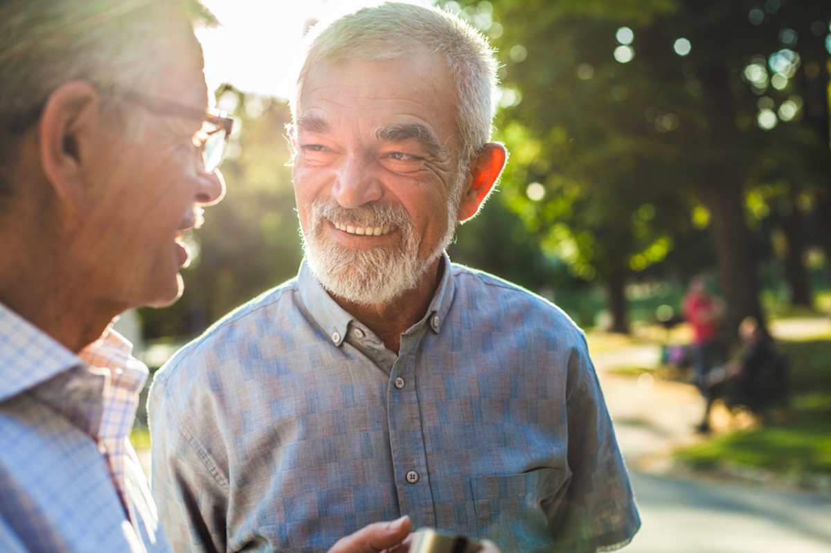 Two senior men chat in the park