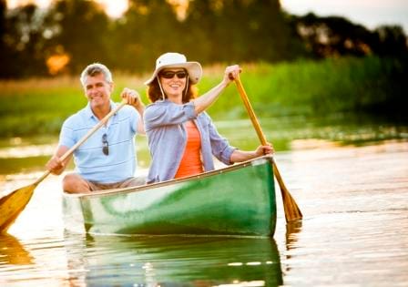 Couple canoeing in water