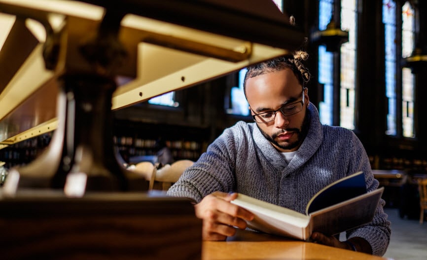 Student reading in a library