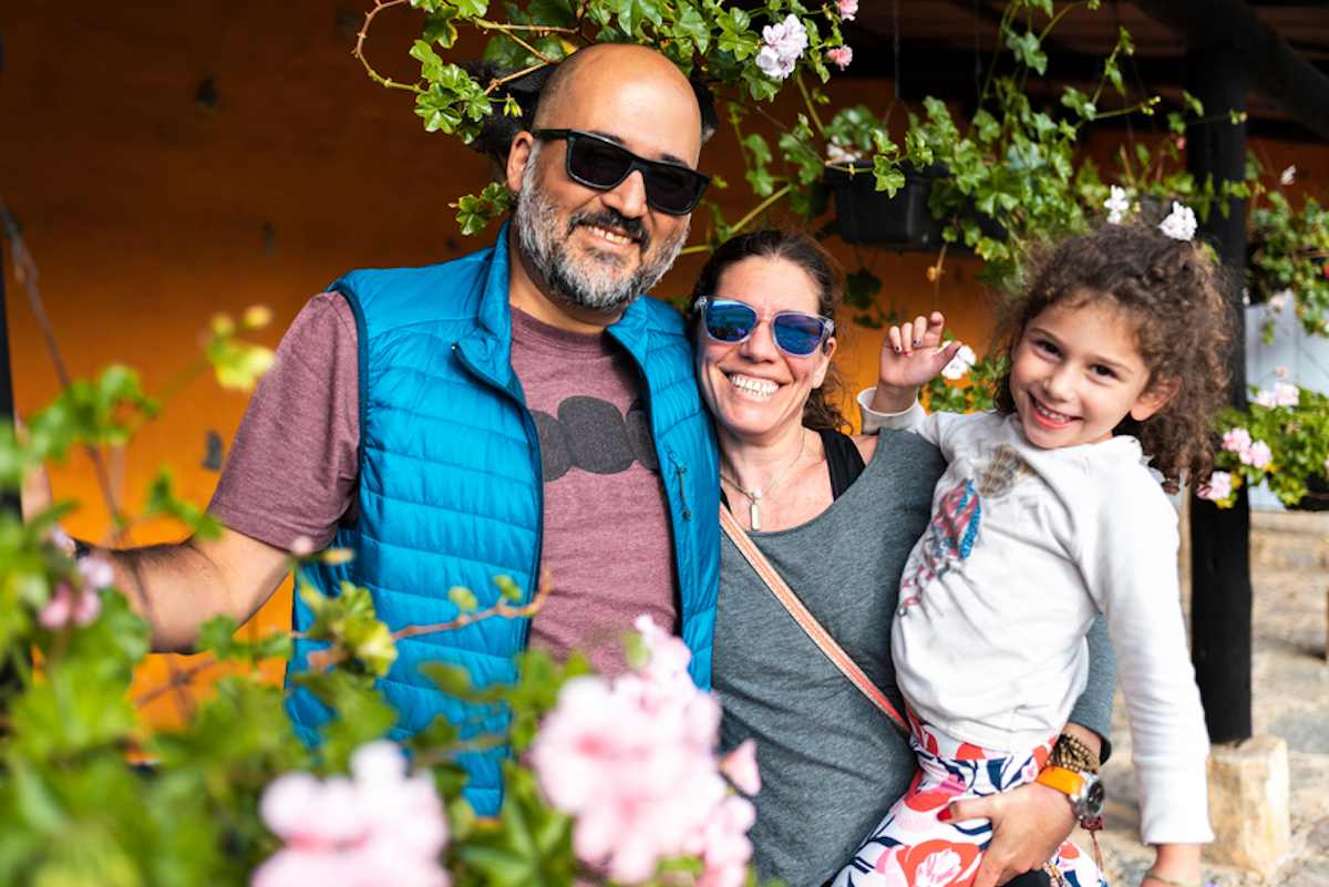 Smiling couple with daughter on vacation