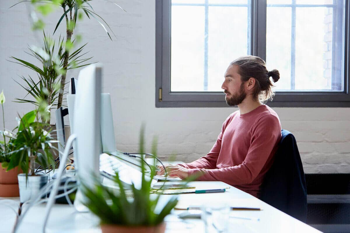 Businessman using computer at desk in office