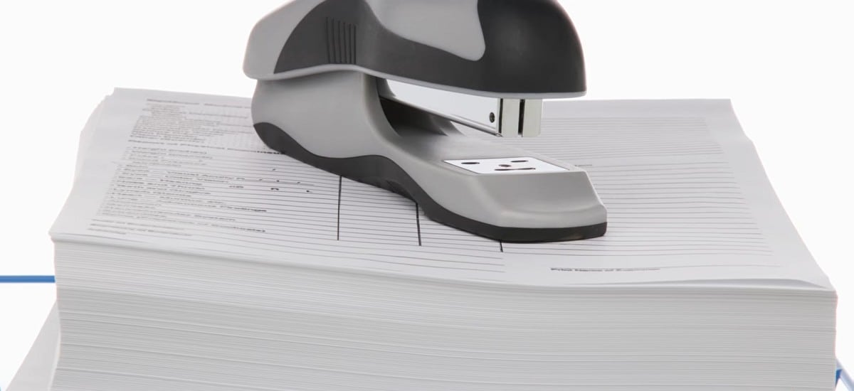 a stapler resting on top of stack of papers