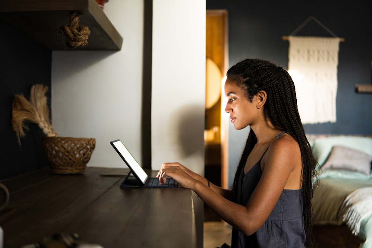 Young woman working at home with her tablet