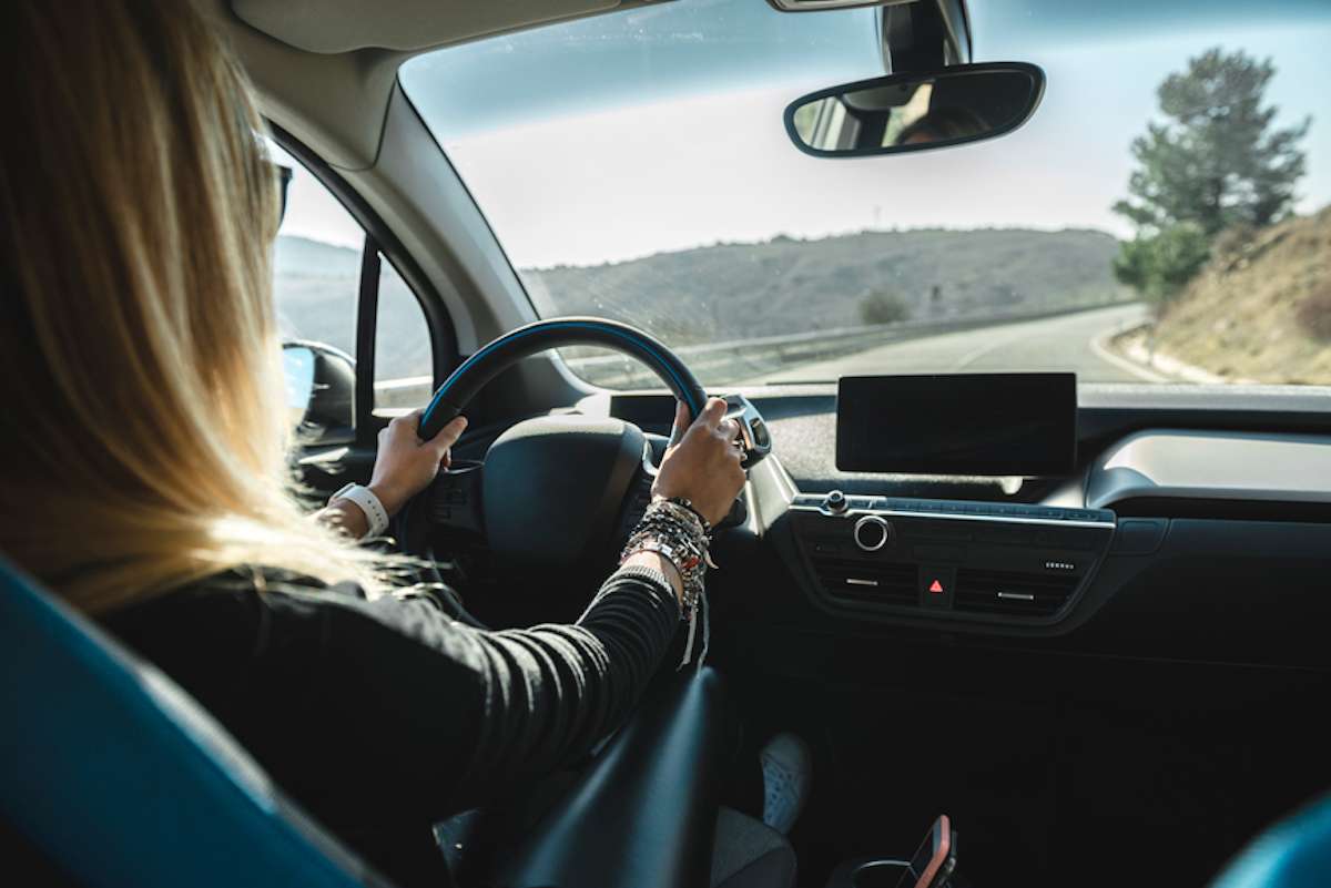 Woman behind the wheel of an electric car