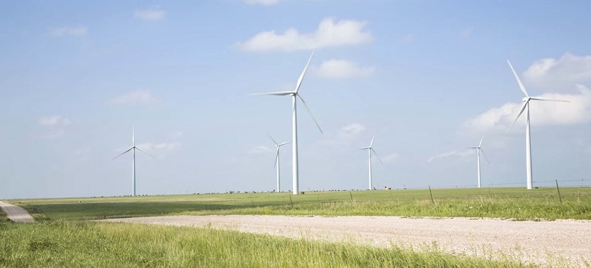 several large wind turbines in a field