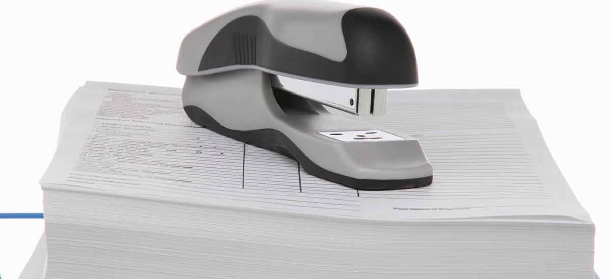 stapler on top of a stack of forms