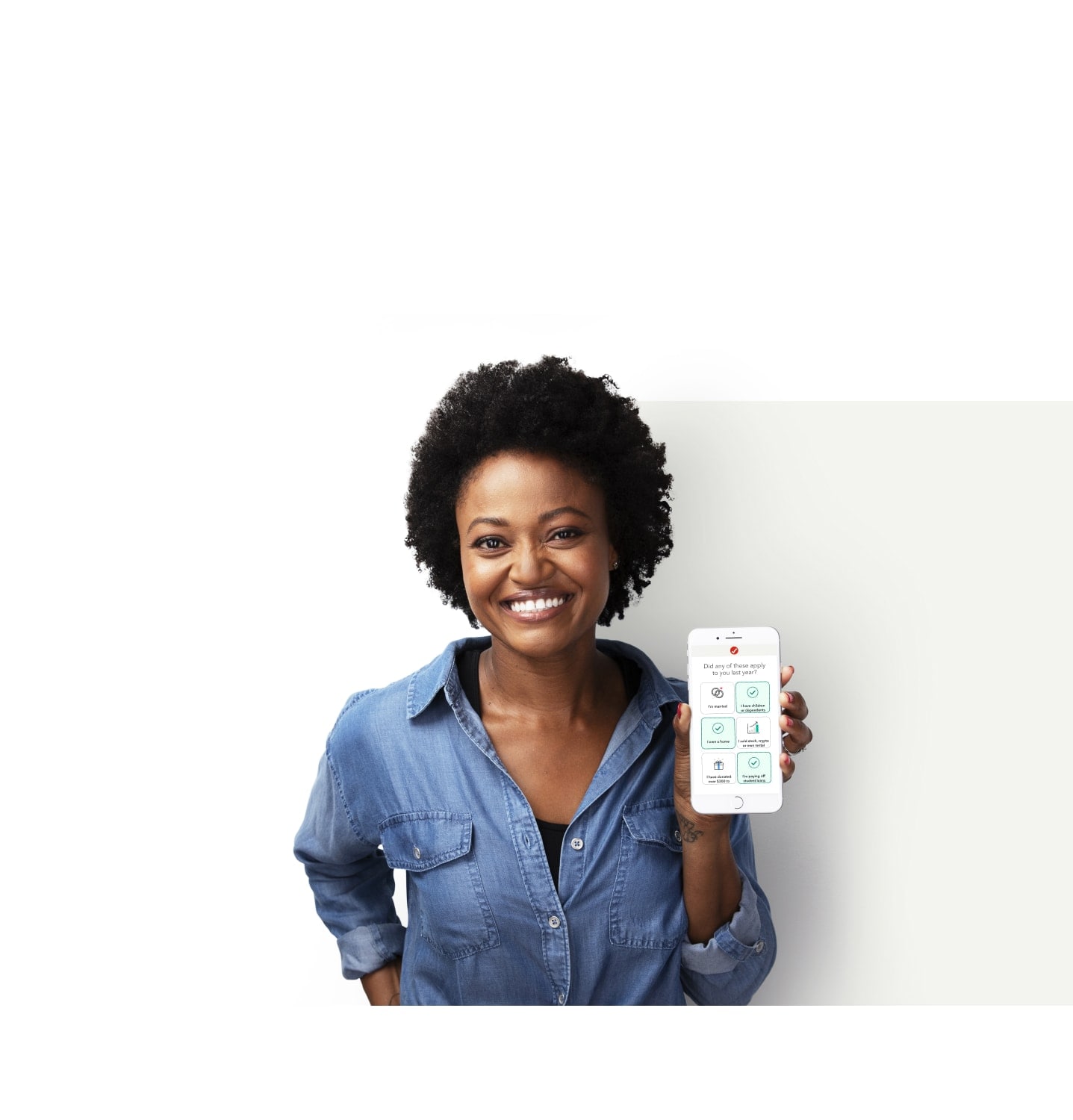 A woman is smiling and excited while holding her phone with a graphic of TurboTax software.