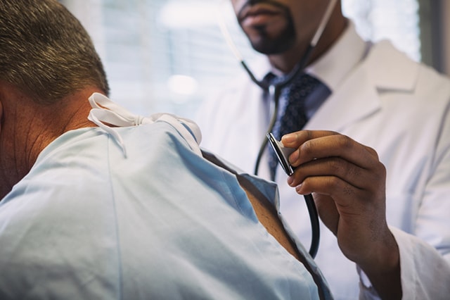 Doctor with stethoscope checking a patient