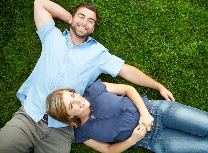 Couple laying grass