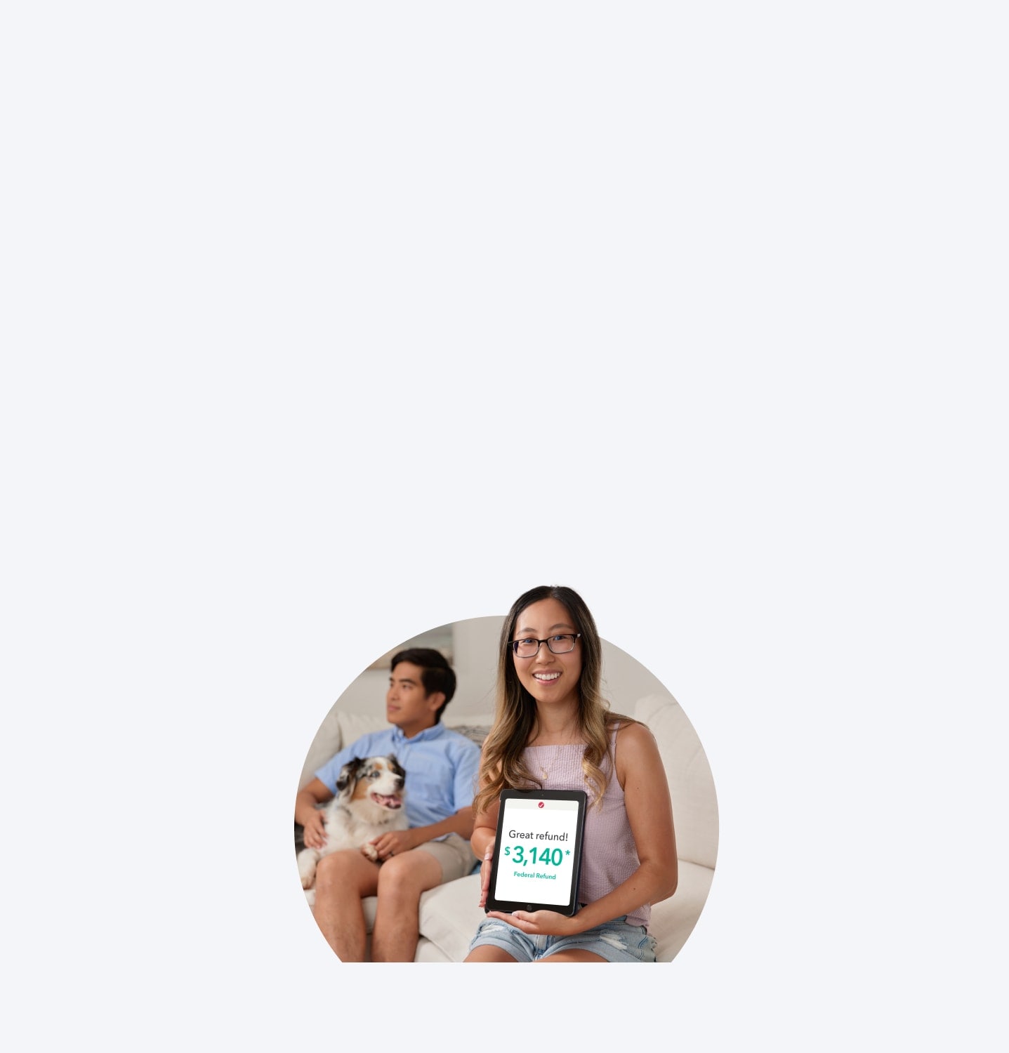 A TurboTax customer is smiling and sitting with her tablet.