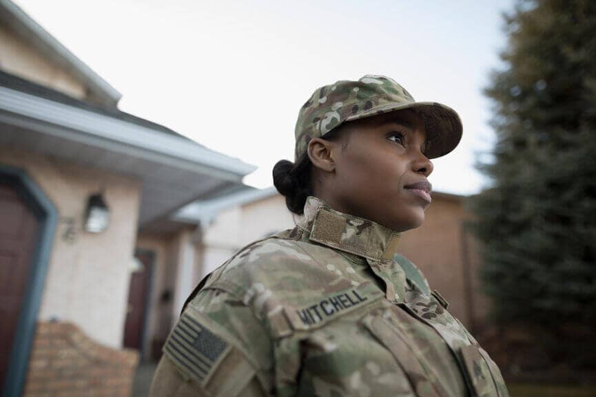 female soldier wearing a uniform in driveway