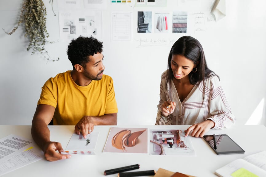 A contractor shares work samples with a smiling client.