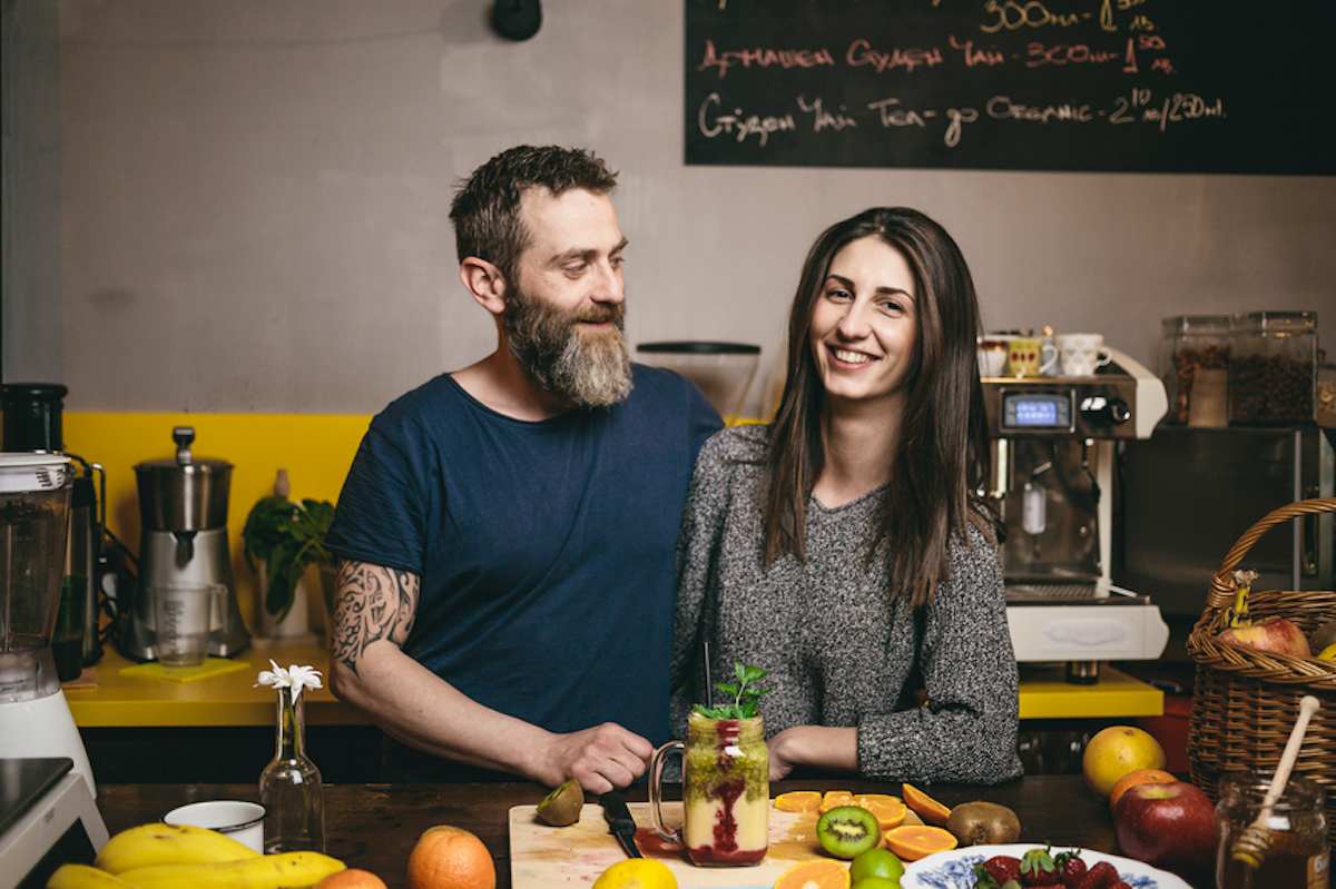 Happy couple proud with their cafe and smoothie bar