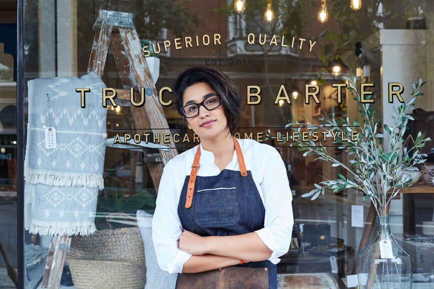 coffee shop owner standing outside of her store