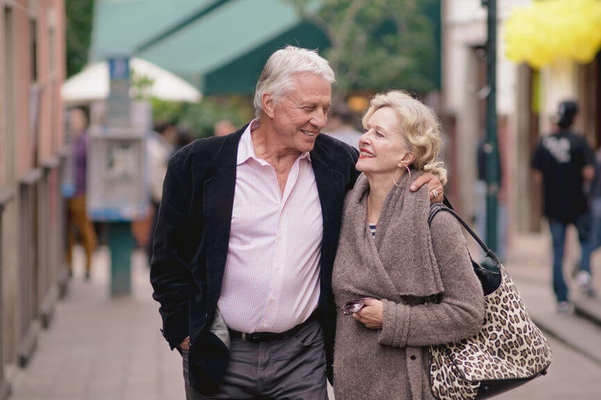 older couple with their arms around each other