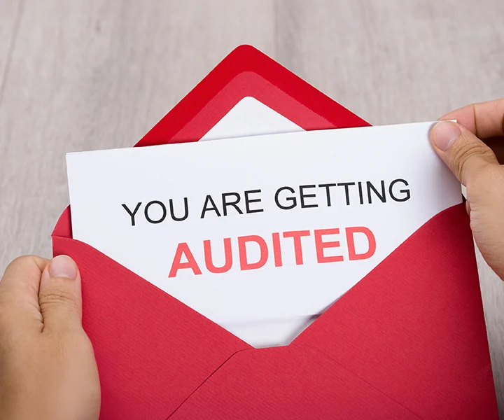 A red sticker on a piece of paper.