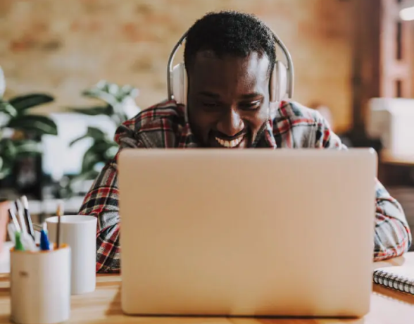 A person sitting at a desk with a laptop computer.