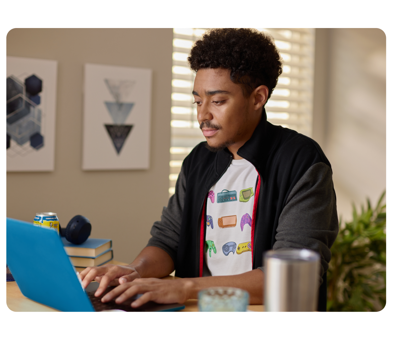 A person sitting at a table with a laptop computer.