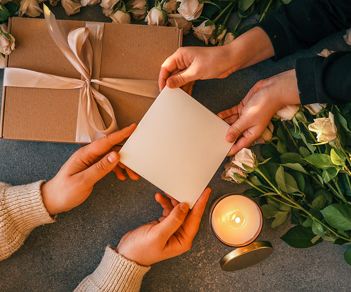 A person holding a piece of paper with a card on it.