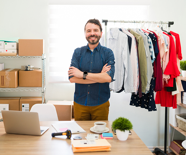 A person standing in a room with a bunch of items.
