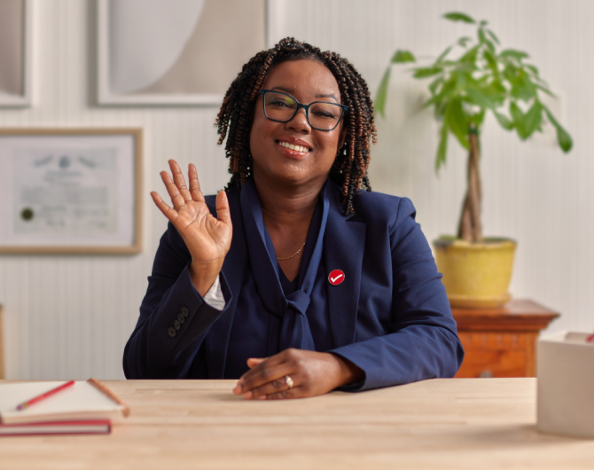 Marla, a TurboTax expert, smiling warmly in her home office.