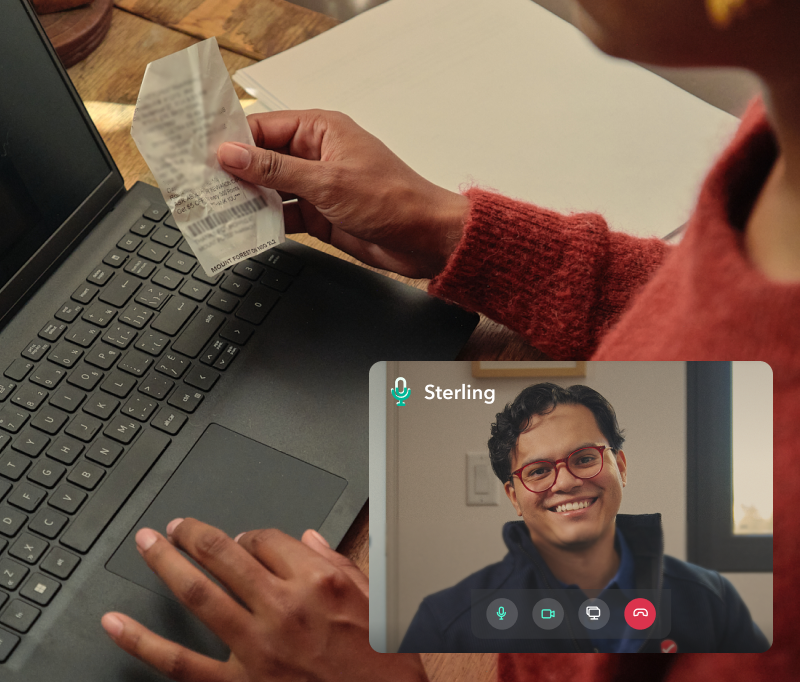 man on a laptop holding notes