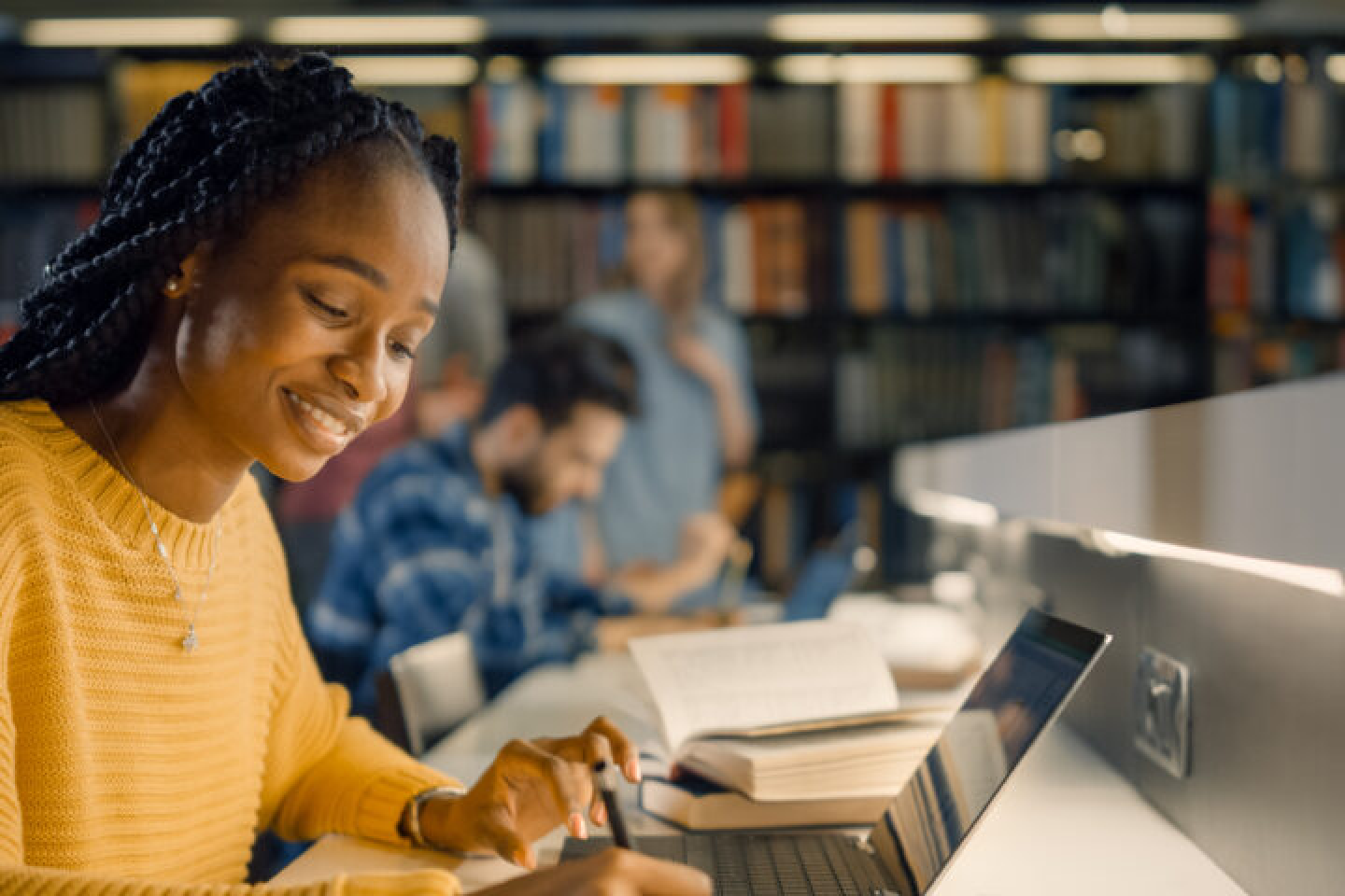 Black student at library working on homework