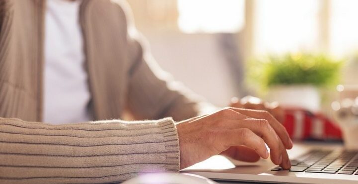 A person is typing on a laptop computer.