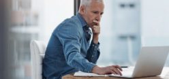 A person sitting at a desk with a laptop.