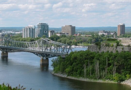 A bridge over a river with a train on it.