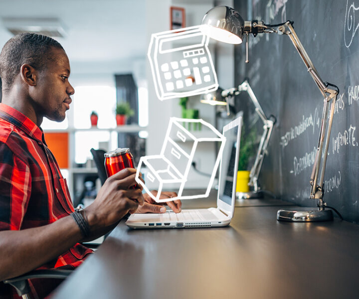 A person sitting at a desk with a laptop computer.