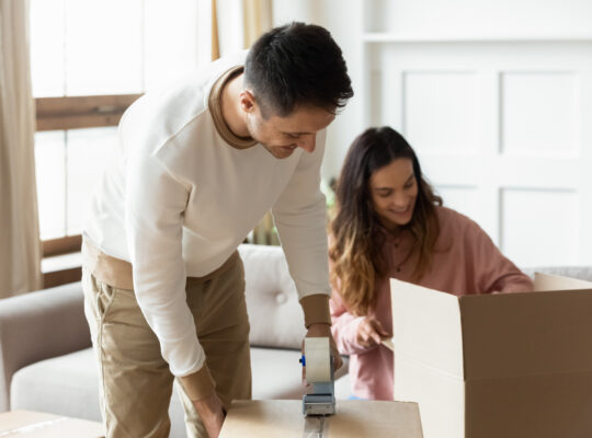 A person and person are in a room with a box.