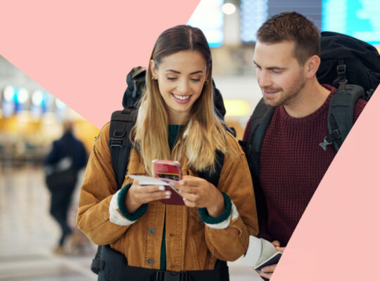 Two person looking at a mobile phone.