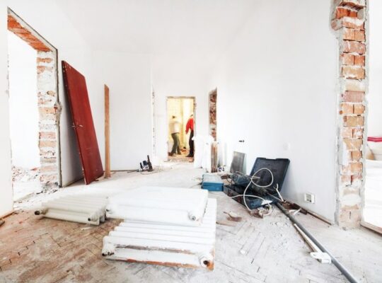 A room with a couch, chair, and a flat screen TV.