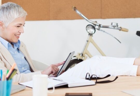 A person sitting at a desk with a laptop computer.