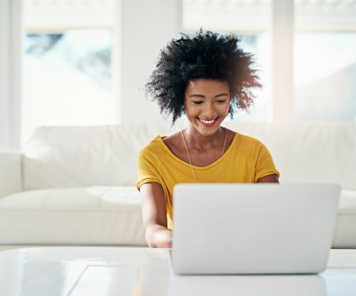 A person sitting in front of a laptop computer.