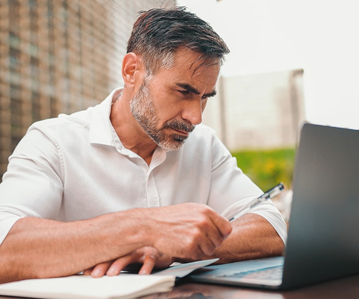 A person sitting at a desk with a laptop computer.